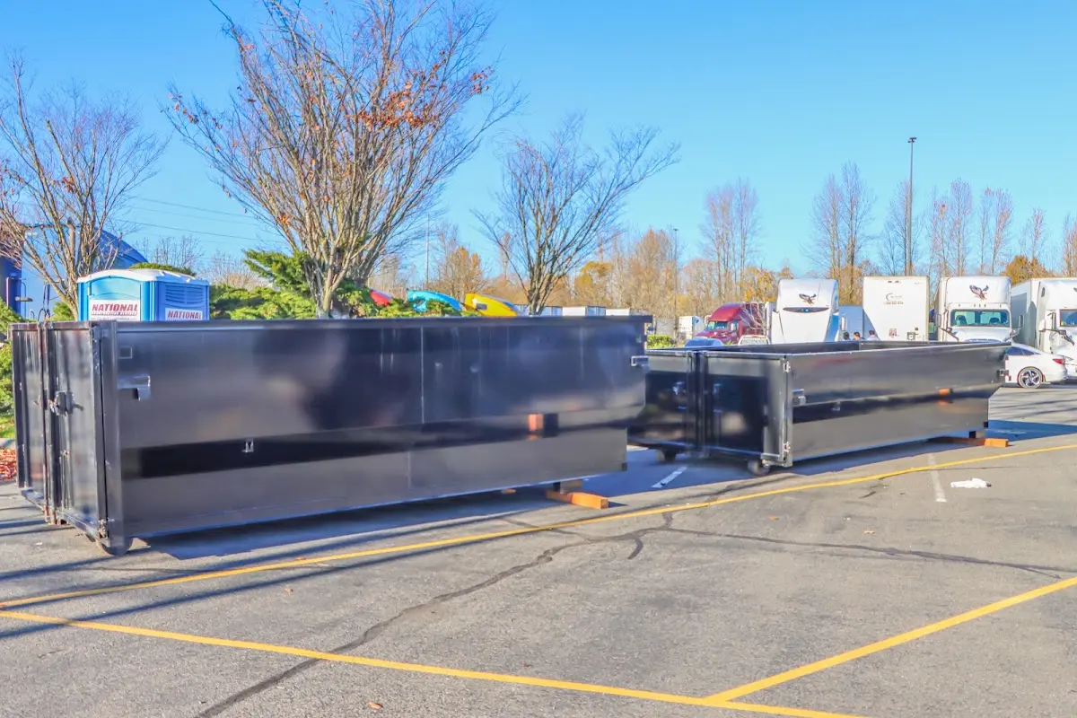Professional dumpster rental service with roll-off container on residential driveway in Brookshire